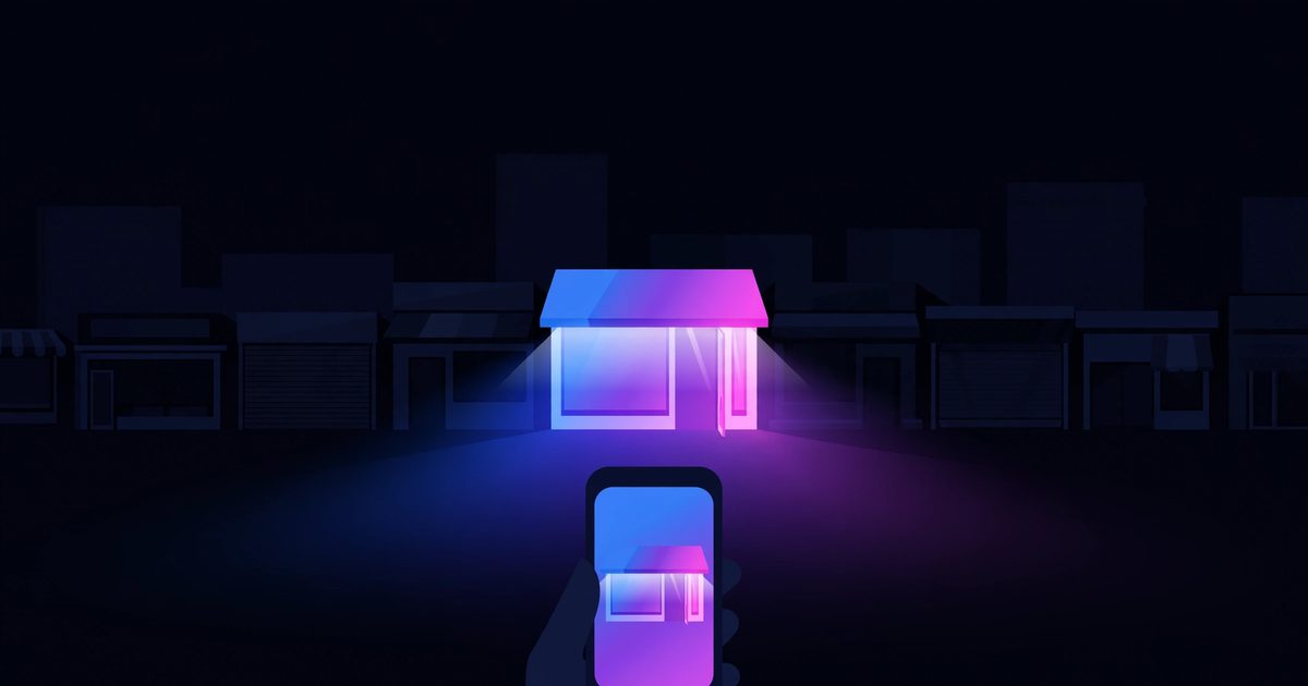 One brightly lit storefront glowing among dark shops at night, seen from a customer's phone